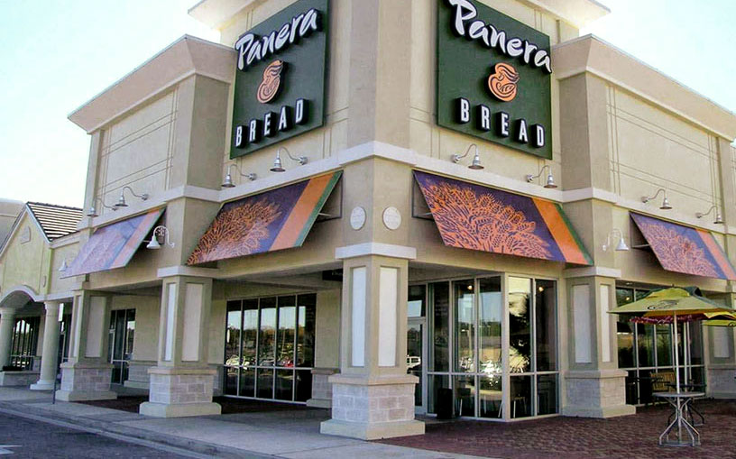 A Panera Bread Building Stands In The Distance. The Fast Casual Was Sold In 2017