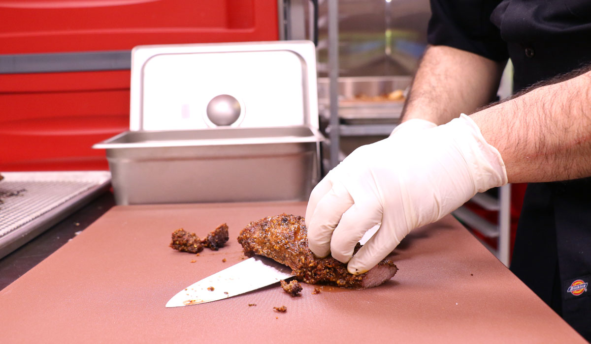 A Chef Slices Chicken Wearing Safety Gloves. Starting Your Own Restaurant Isn't Easy, But It's Often Worth It