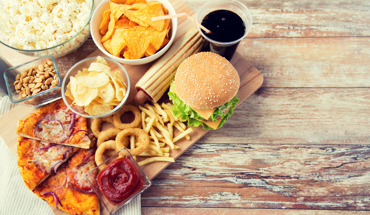 Close Up Of Fast Food Snacks And Drink On Table