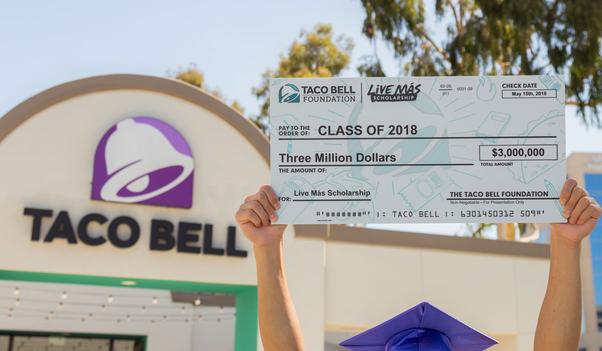 Taco Bell Employee Holds Up A Check For $3 Million