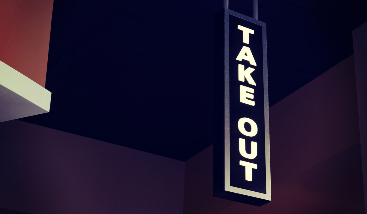 A Take Out Sign In Front Of A Restaurant