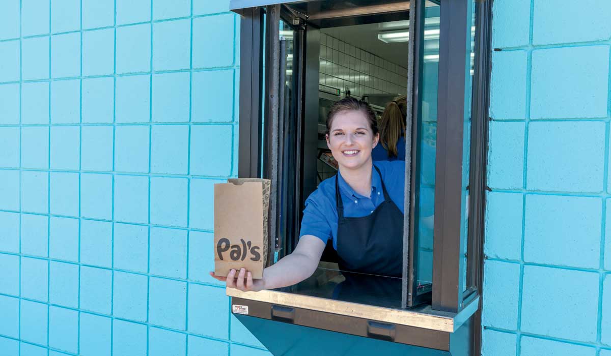 Employee At Drive Thru Window At Pal's Sudden Service