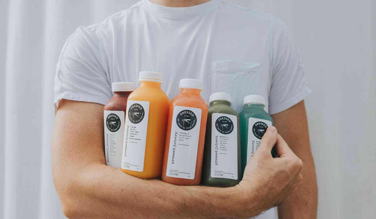 Person Holding Bottles Of Pressed Juicery Juices