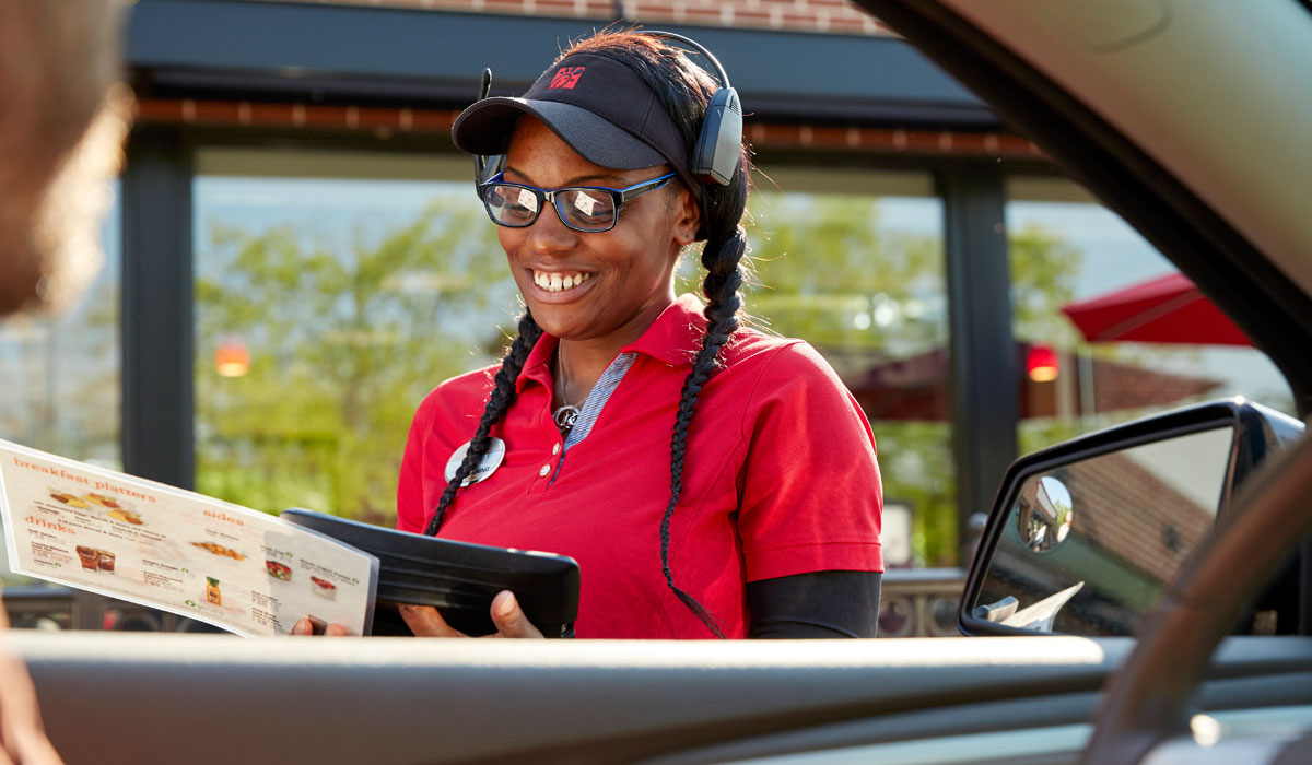 A Chick Fil A Worker Takes An Order At The Car In The Drive Thru