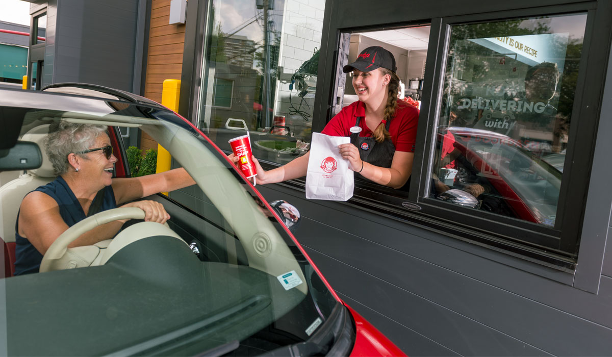 wendys-gets-ready-breakfast-rush Wendy's Employee Serves A Customer Through The Drive Thru Lane