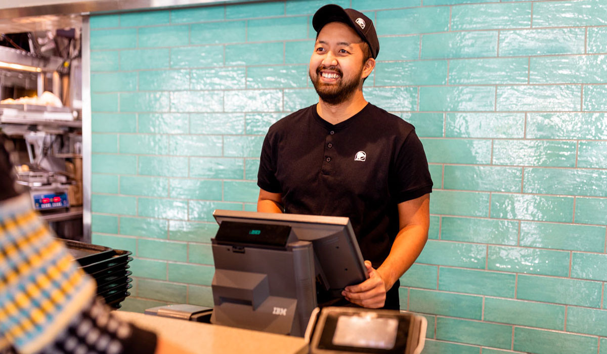 A Taco Bell Employee Takes An Order At The Register