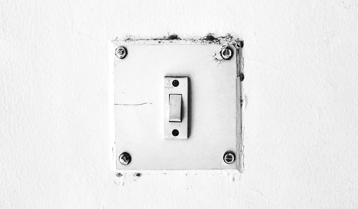 White Light Switch On A White Wall
