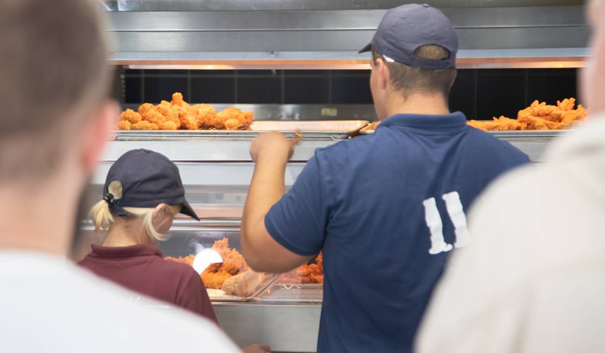 Staff Inside A Fast Food Restaurant Making Chicken