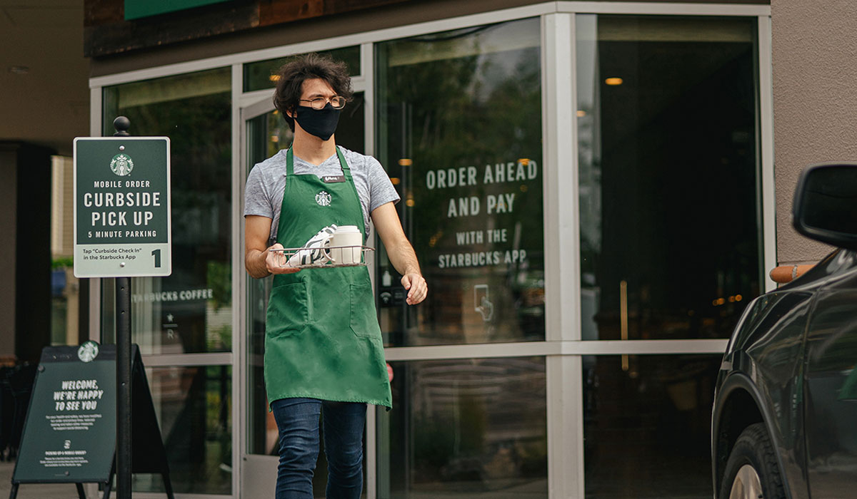 Starbucks Employee Walks An Order Out To A Car