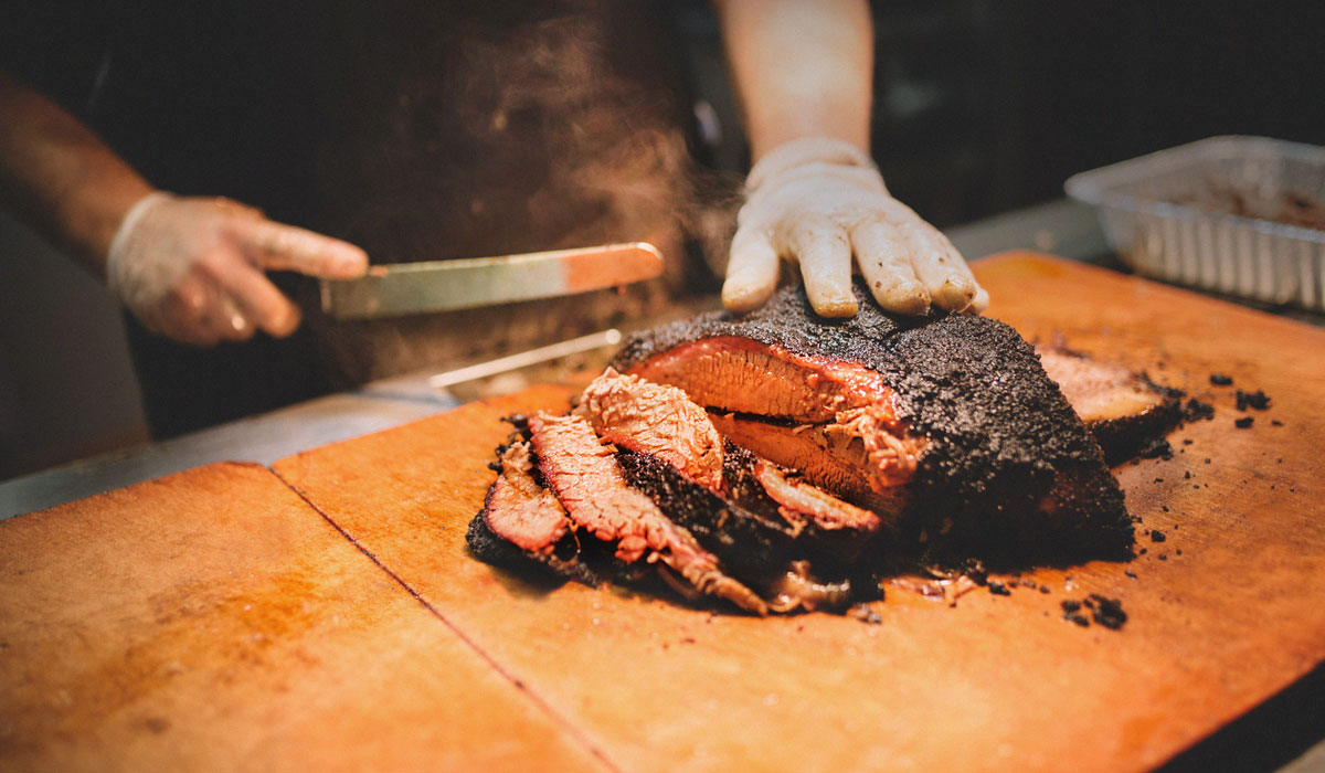 Brisket Being Sliced On A Cutting Board At City Barbecue