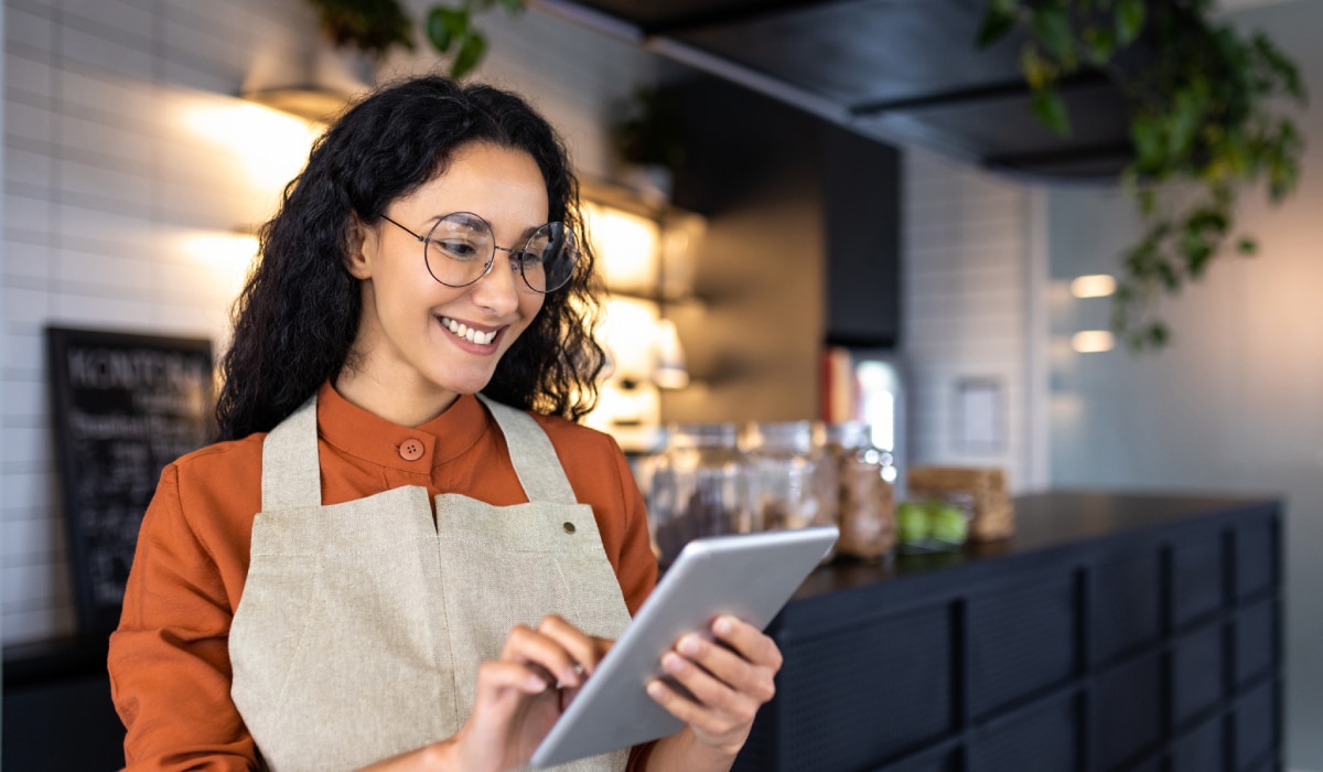 Restaurant worker using a tablet.