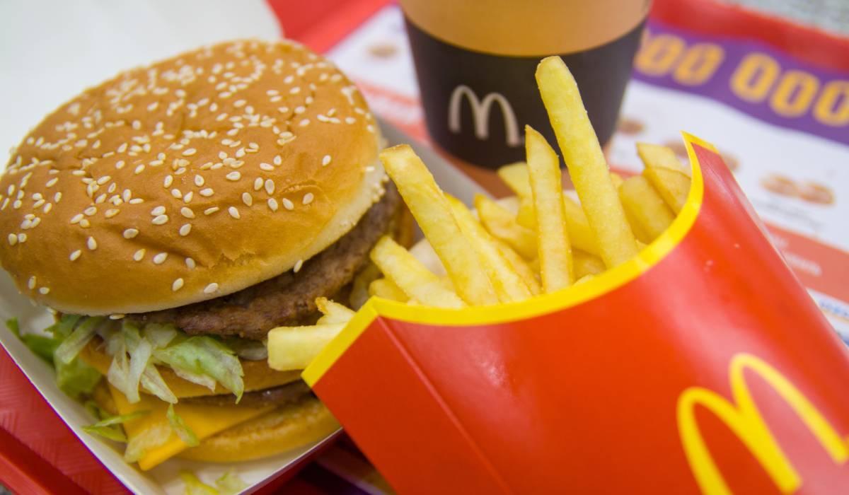 McDonald's burger and fries and coffee on tray.