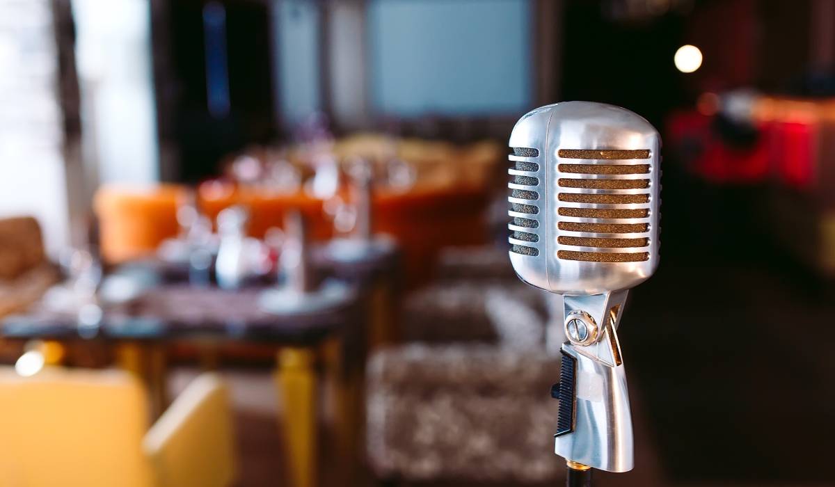 Retro karaoke microphone on restaurant background.