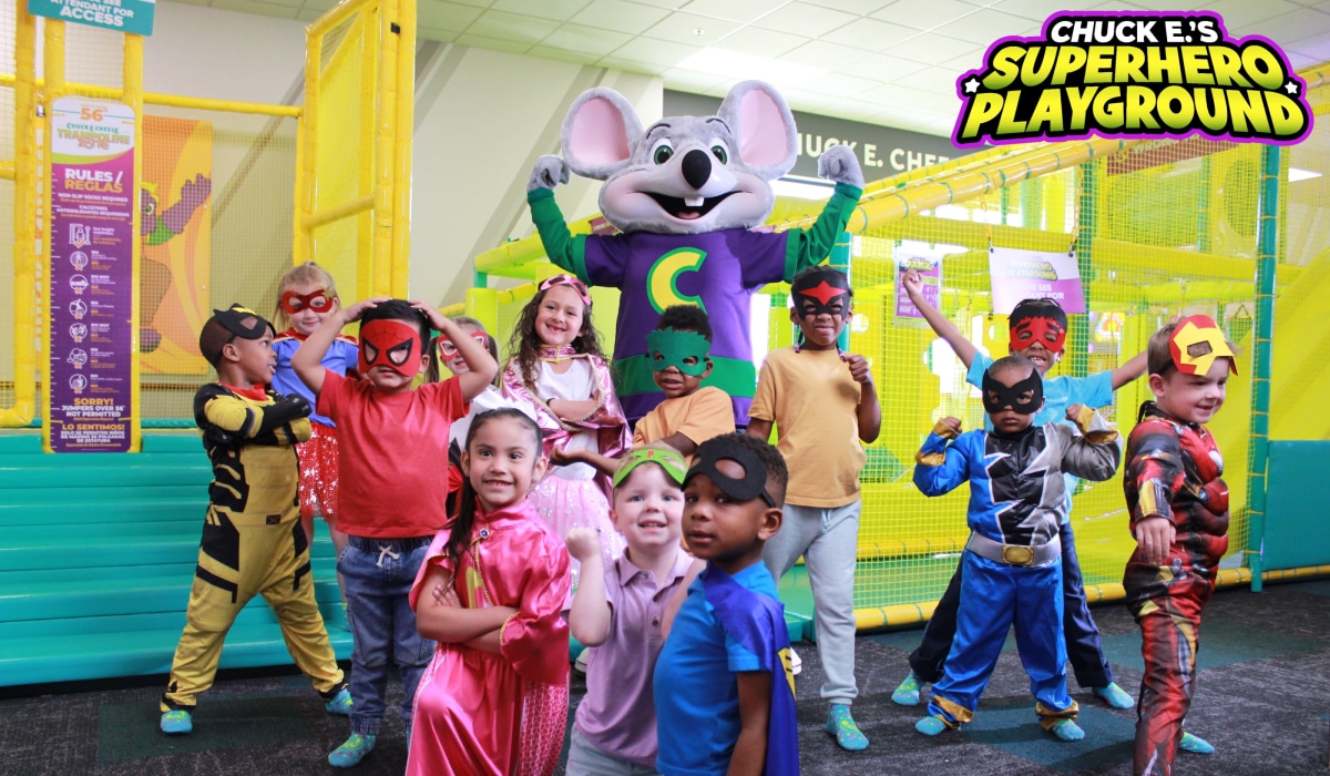 Chuck E. Cheese's active play area with kids dressed as super heroes.