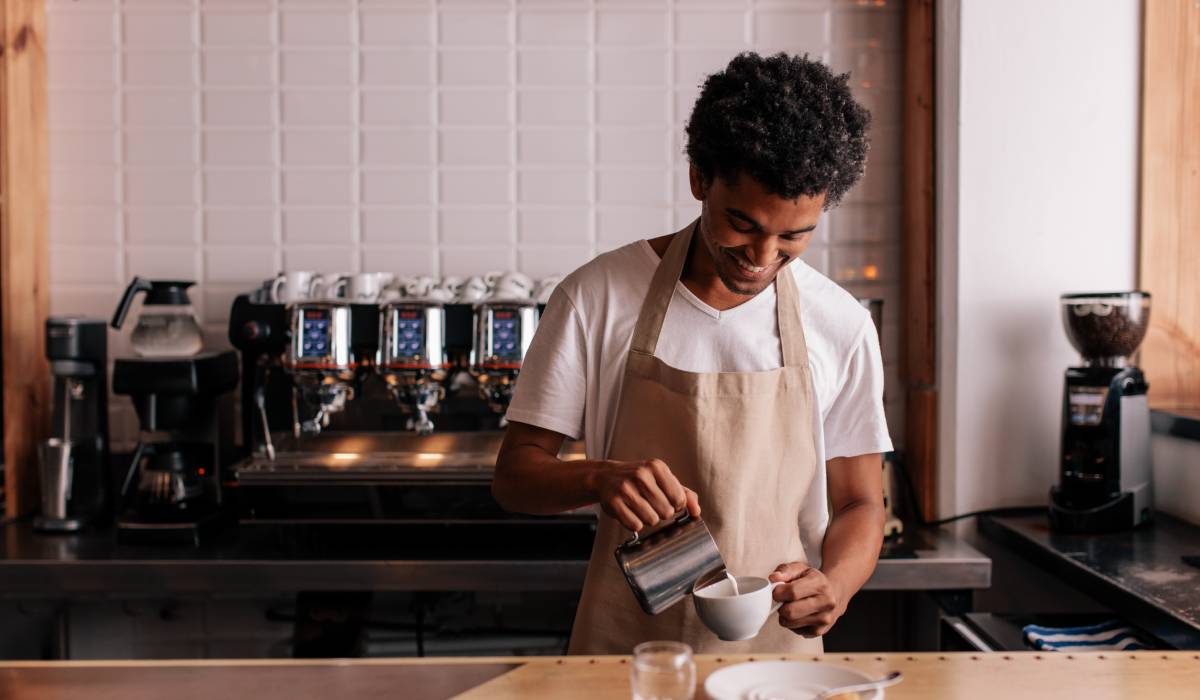 Professional barista preparing coffee on counter.