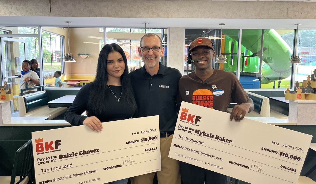 Mykale Baker being presented with the check.