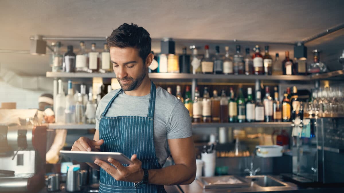 Restaurant employee with a tablet.