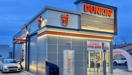 Dunkin' restaurant freestanding at night.