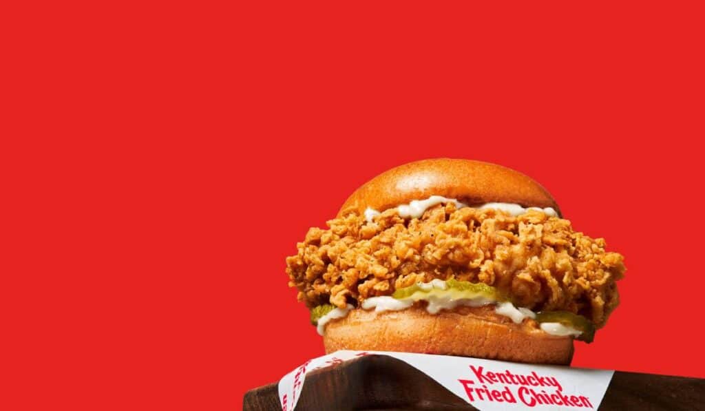 KFC sandwich against a red background.