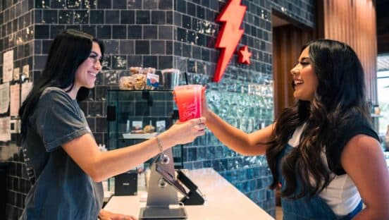 Black Rock Coffee Bar customer getting a drink from an employee.