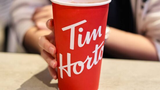 Tim Hortons red cup held by a customer.