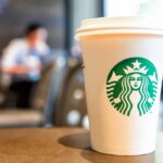 Starbucks cup on table.