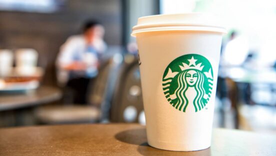 Starbucks cup on table.