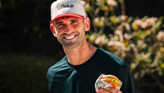 Carl Radke holding Carl's Jr. burger.