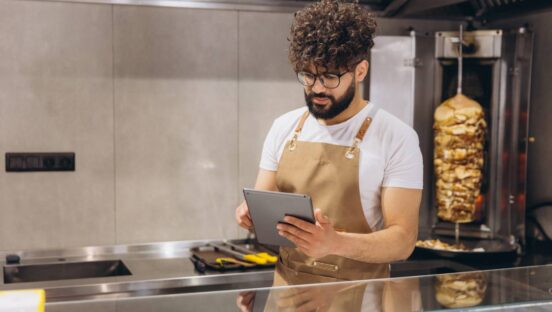 Chef looking at a tablet.