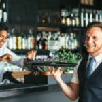 Waiter holding cocktail tray.