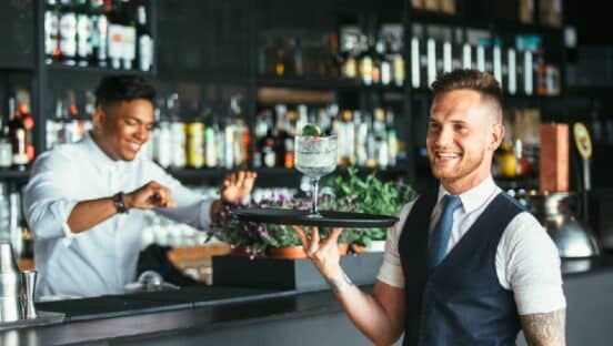 Waiter holding cocktail tray.