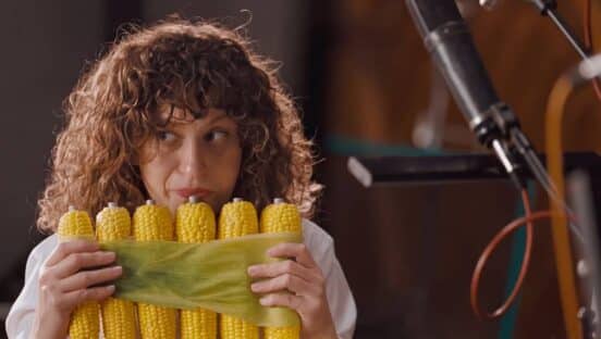 Person playing instrument with corn.