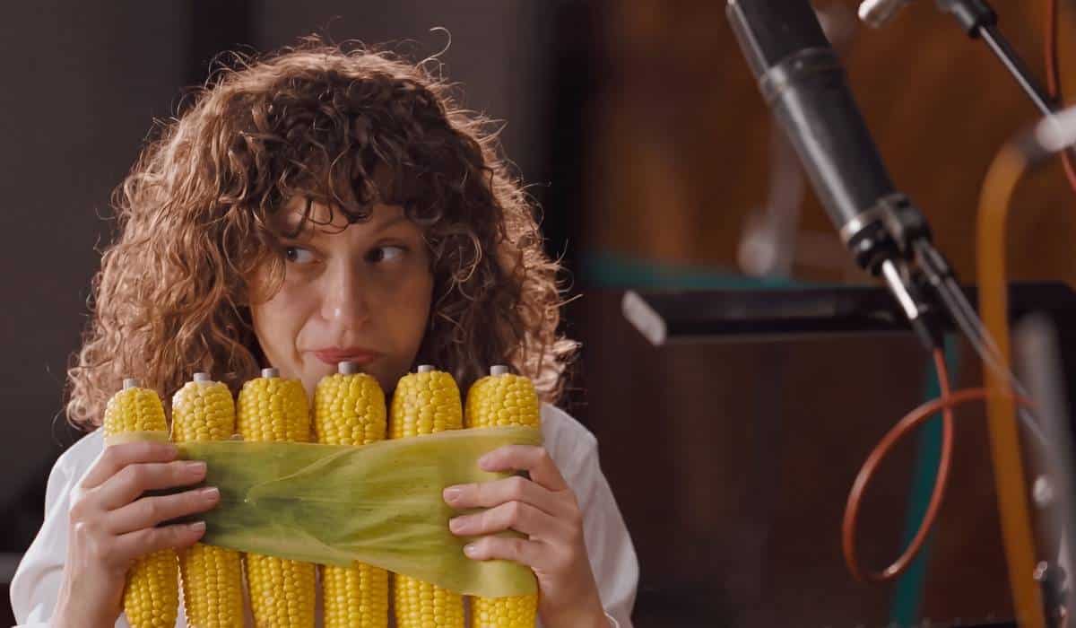 Person playing instrument with corn.